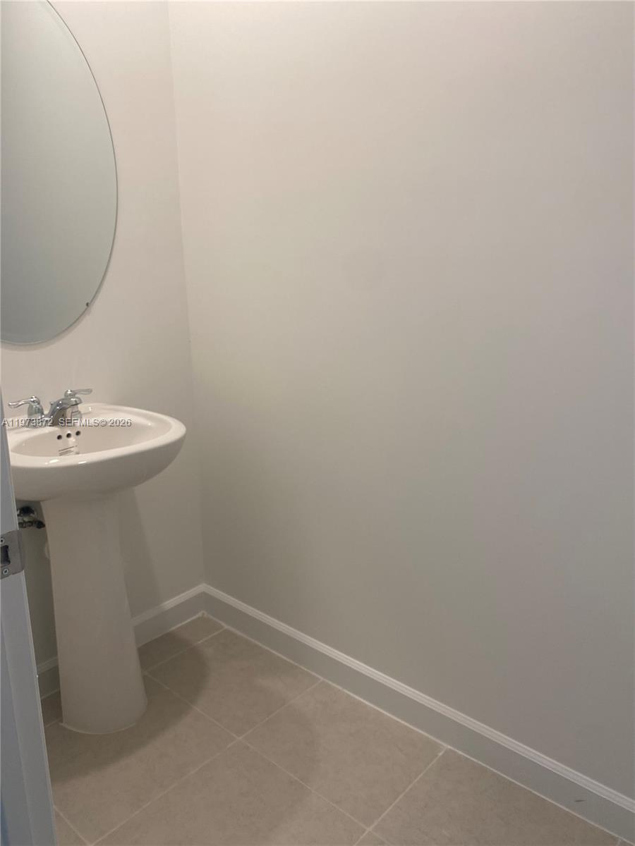 27559 Southwest 159th Place Homestead, FL 33033 - Photo 11 of 14 a bathroom with a sink and a mirror