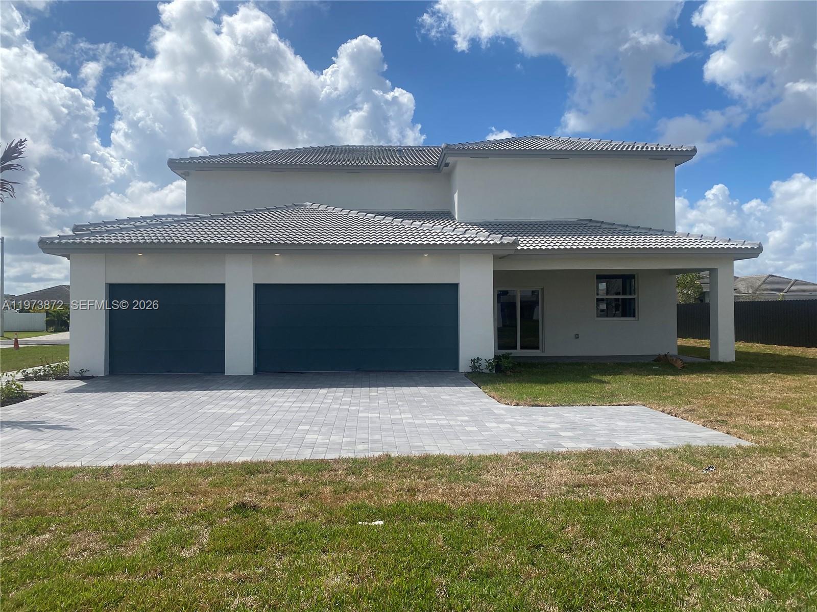 27559 Southwest 159th Place Homestead, FL 33033 - Photo 2 of 14 a front view of a house with a yard and garage