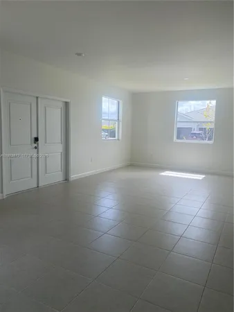 an empty room with a empty space and windows