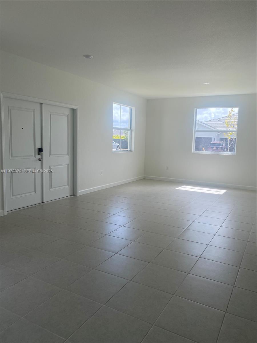 27559 Southwest 159th Place Homestead, FL 33033 - Photo 4 of 14 a view of an empty room with a window