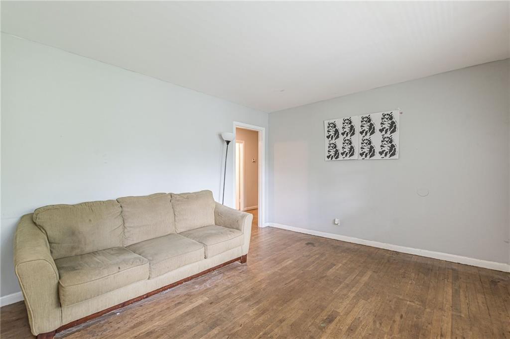 a living room with furniture and a wall with kitchen