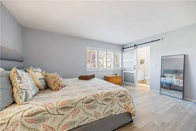 a bedroom with a bed and lamp