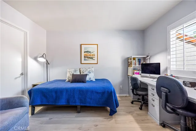 a bedroom with furniture and a window