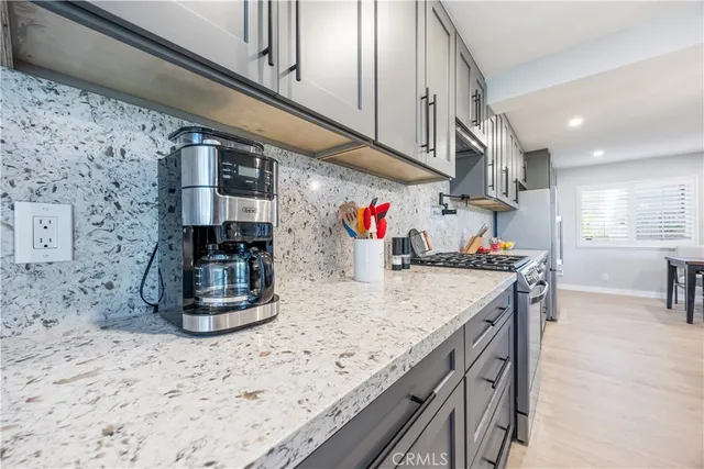 a kitchen with stainless steel appliances granite countertop a sink and cabinets