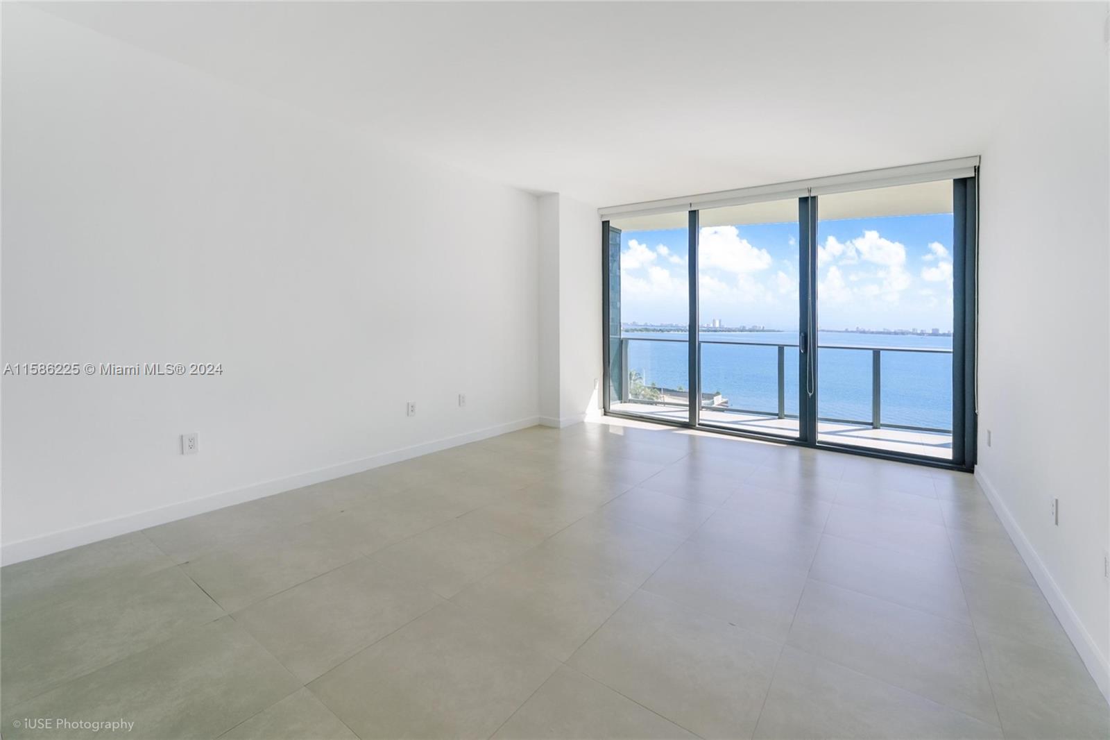 460 Northeast 28th Street, Unit 806 Miami, FL 33137 - Photo 13 of 19 an empty room with wooden floor and windows