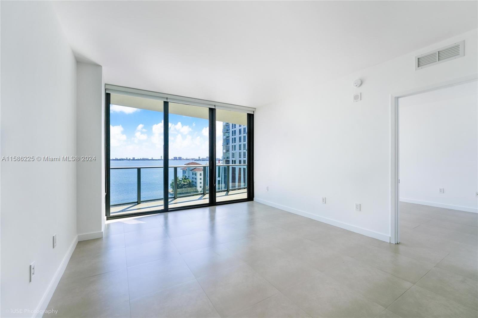 460 Northeast 28th Street, Unit 806 Miami, FL 33137 - Photo 17 of 19 wooden floor in an empty room with a window