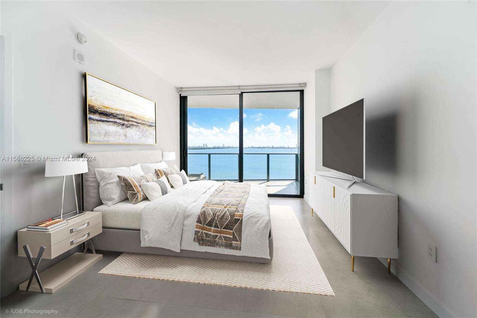 460 Northeast 28th Street, Unit 806 Miami, FL 33137 - Photo 2 of 19 a bedroom with a bed and a flat screen tv