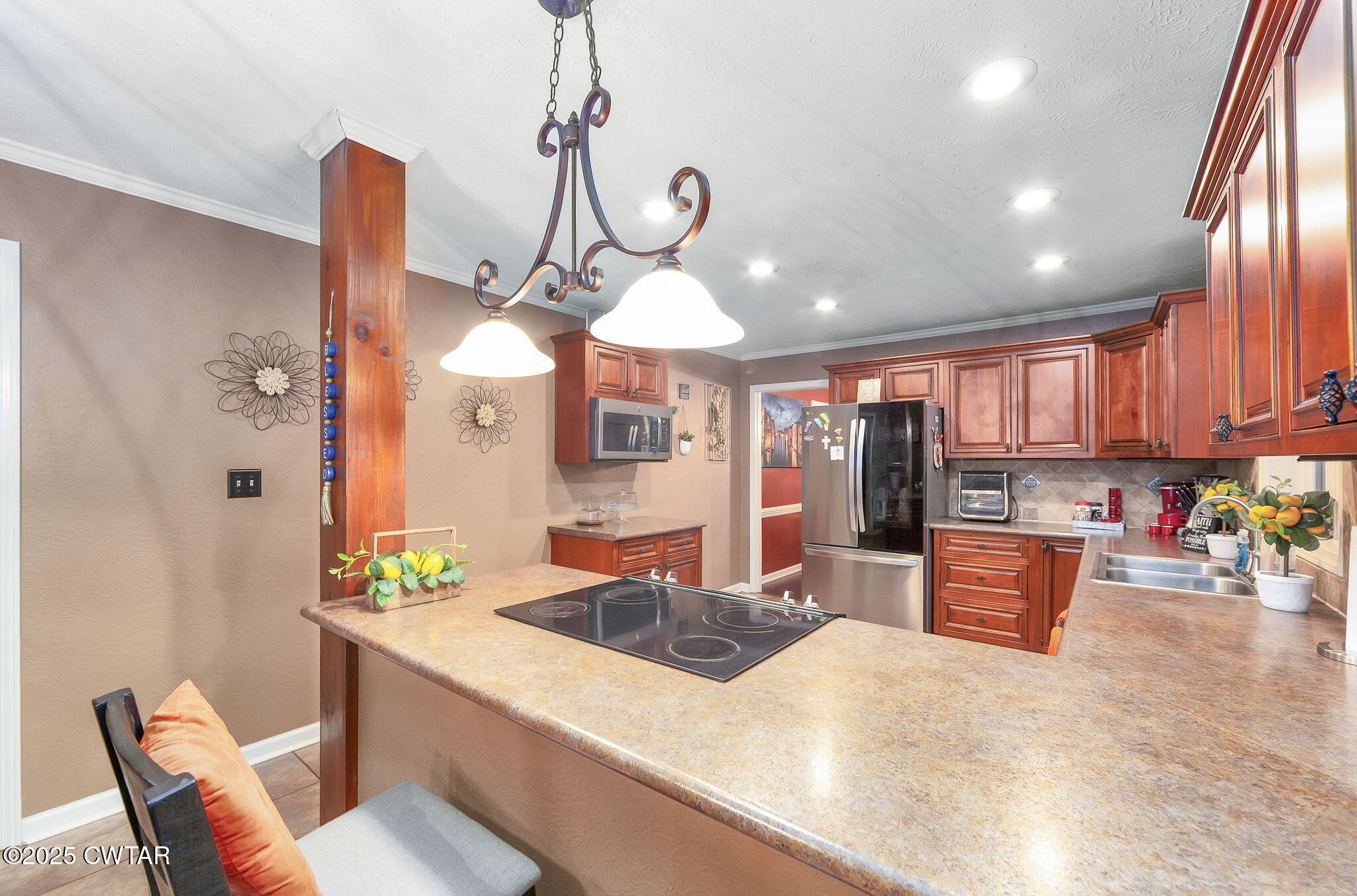 117 Tuckahoe Road Jackson, TN 38305 - Photo 11 of 57 a kitchen with stainless steel appliances granite countertop a sink a stove and refrigerator