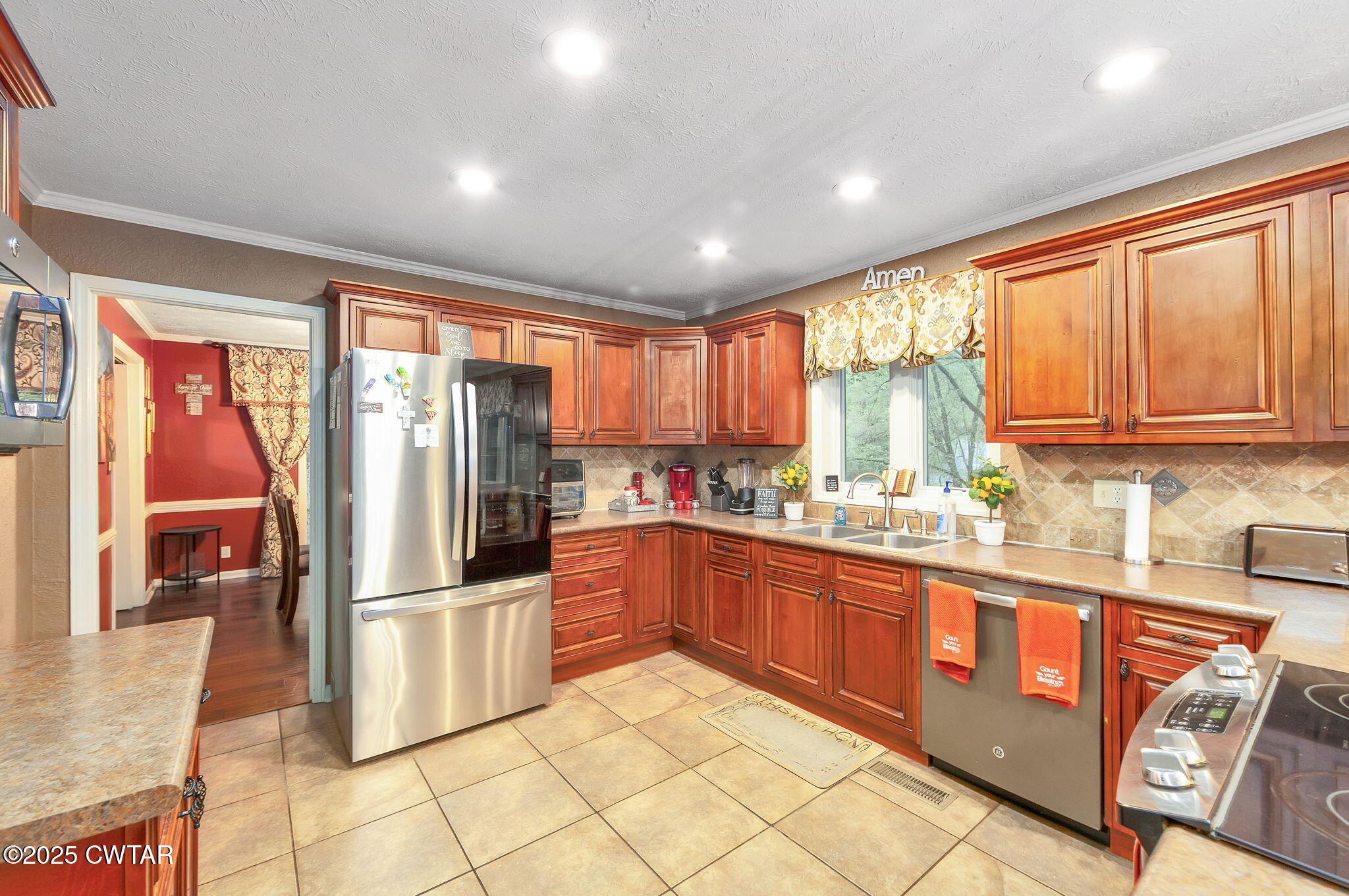 117 Tuckahoe Road Jackson, TN 38305 - Photo 12 of 57 a kitchen with stainless steel appliances granite countertop a refrigerator and a sink
