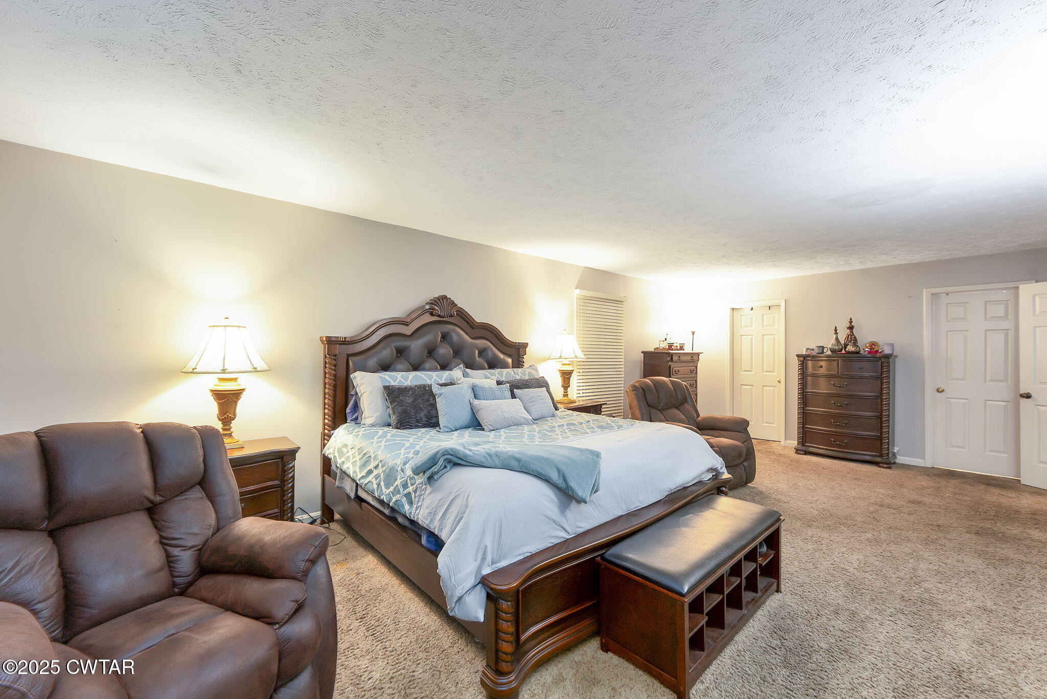 117 Tuckahoe Road Jackson, TN 38305 - Photo 20 of 57 a spacious bedroom with a bed a couch and a large window