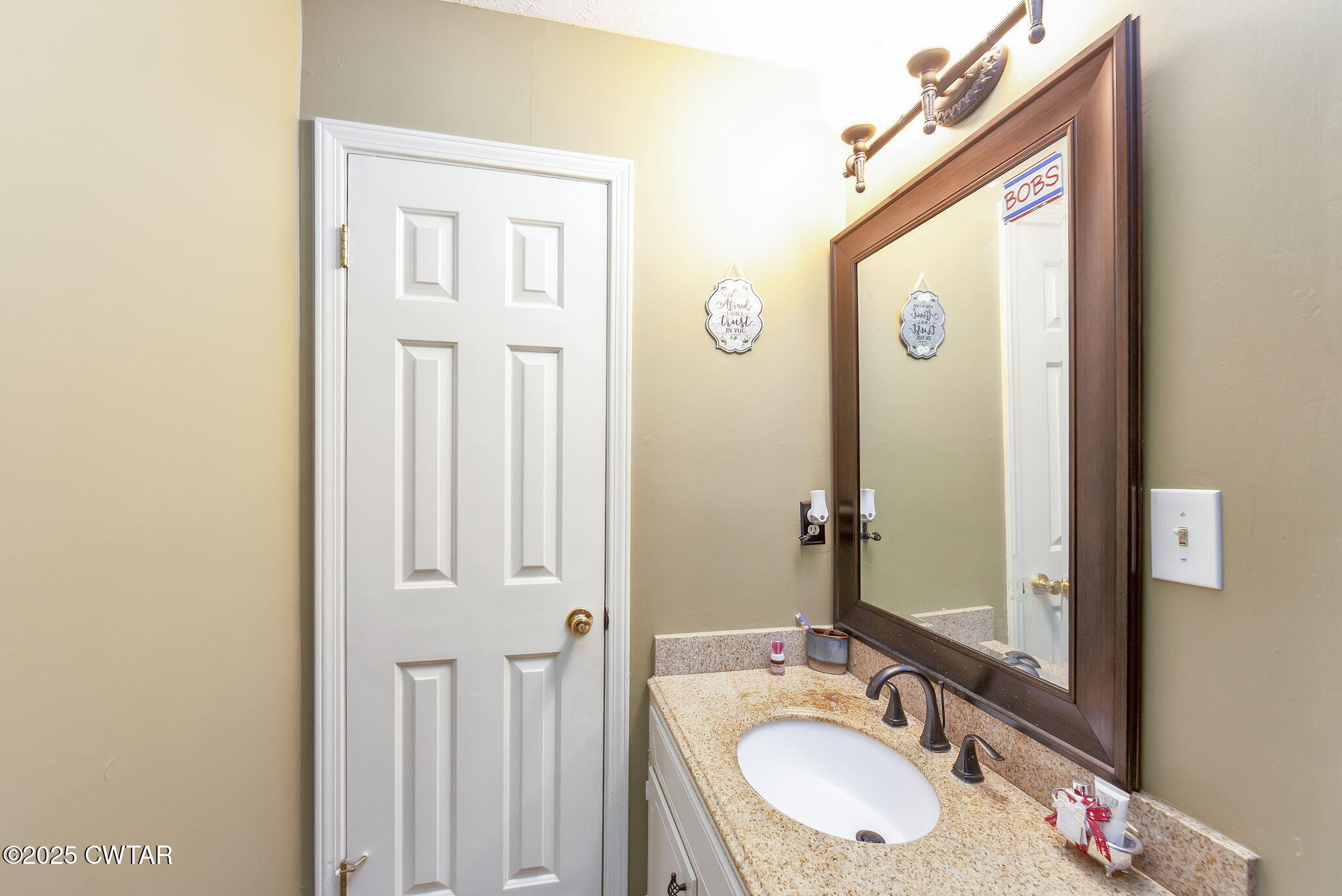 117 Tuckahoe Road Jackson, TN 38305 - Photo 25 of 57 a bathroom with a granite countertop sink vanity and mirror