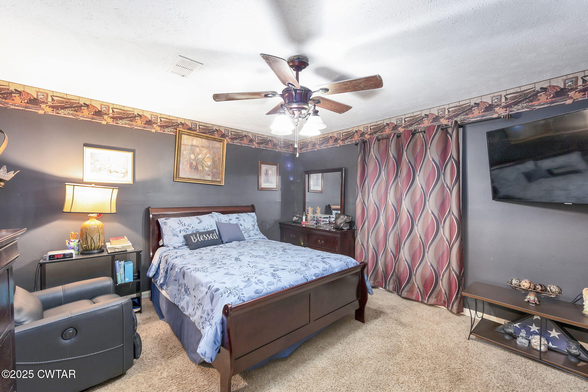 117 Tuckahoe Road Jackson, TN 38305 - Photo 28 of 57 a bedroom with a bed and a chandelier
