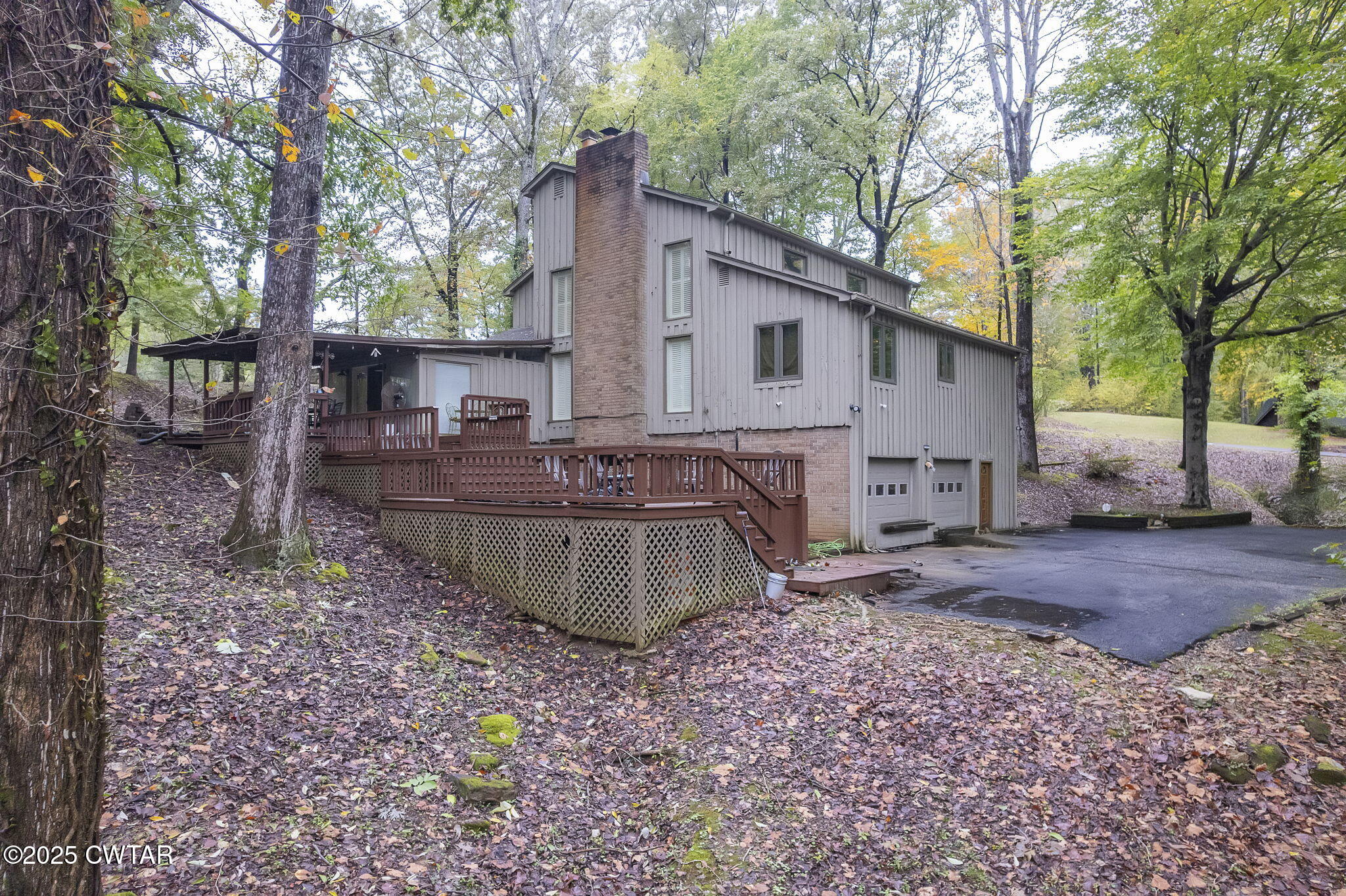 117 Tuckahoe Road Jackson, TN 38305 - Photo 56 of 57 a view of a backyard with large trees and wooden fence