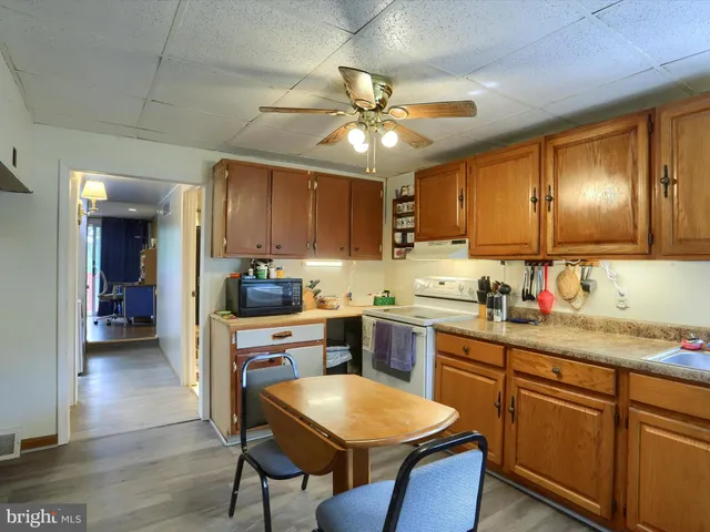 a kitchen with a table chairs sink and cabinets