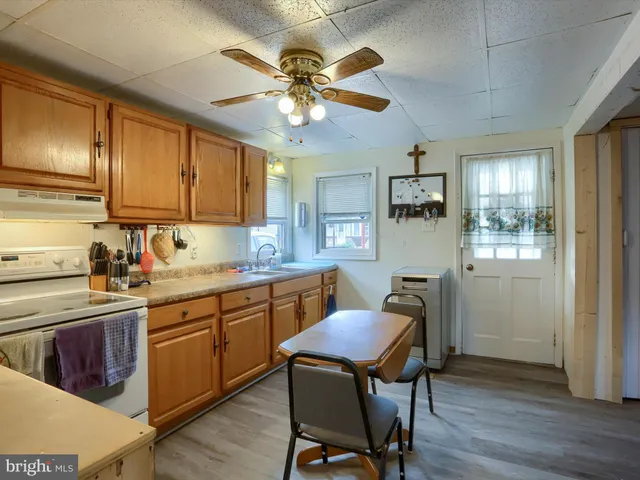 a kitchen with a table chairs and wooden cabinets