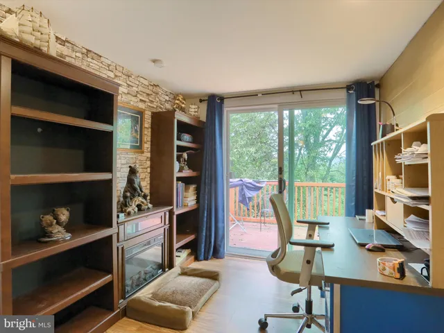 a living room with furniture a flat screen tv and a floor to ceiling window