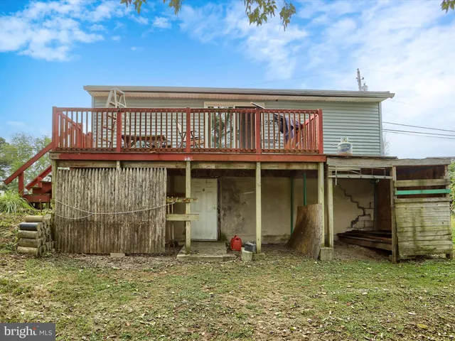 a view of a house with backyard porch and wooden fence