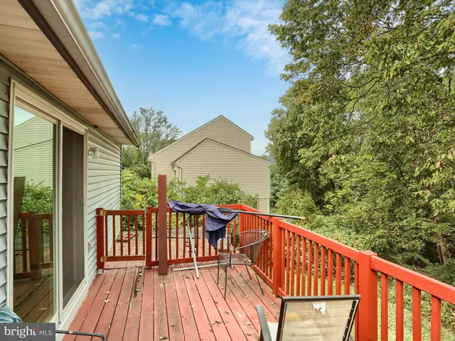 a balcony with wooden floor and outdoor seating