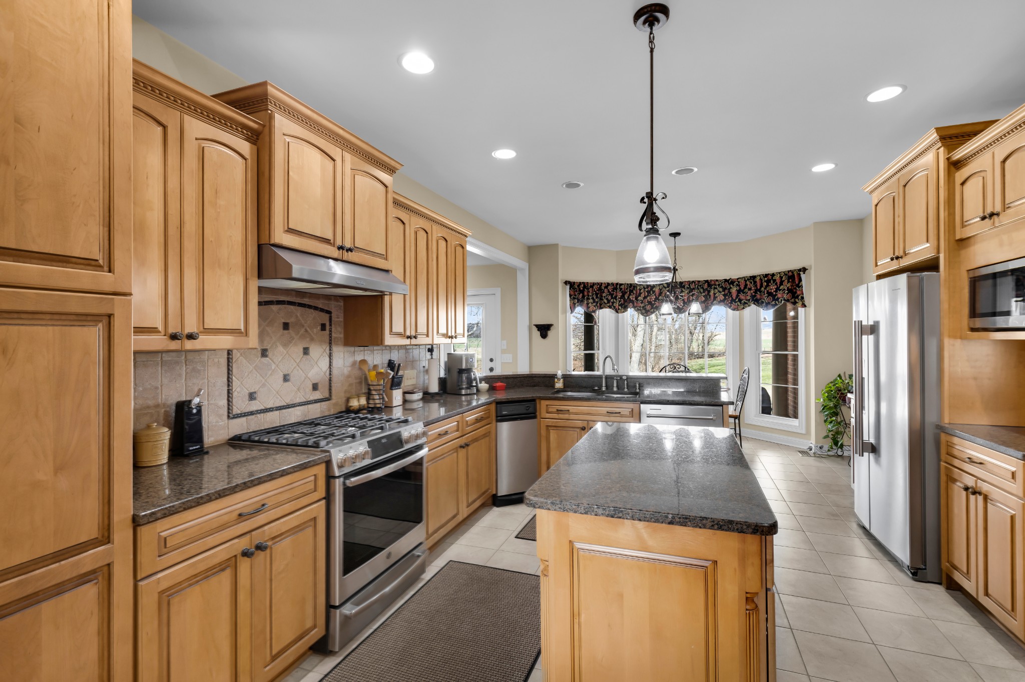 5144 Drake Road Cedar Hill, TN 37032 - Photo 11 of 80 a kitchen with stainless steel appliances granite countertop a sink stove and refrigerator