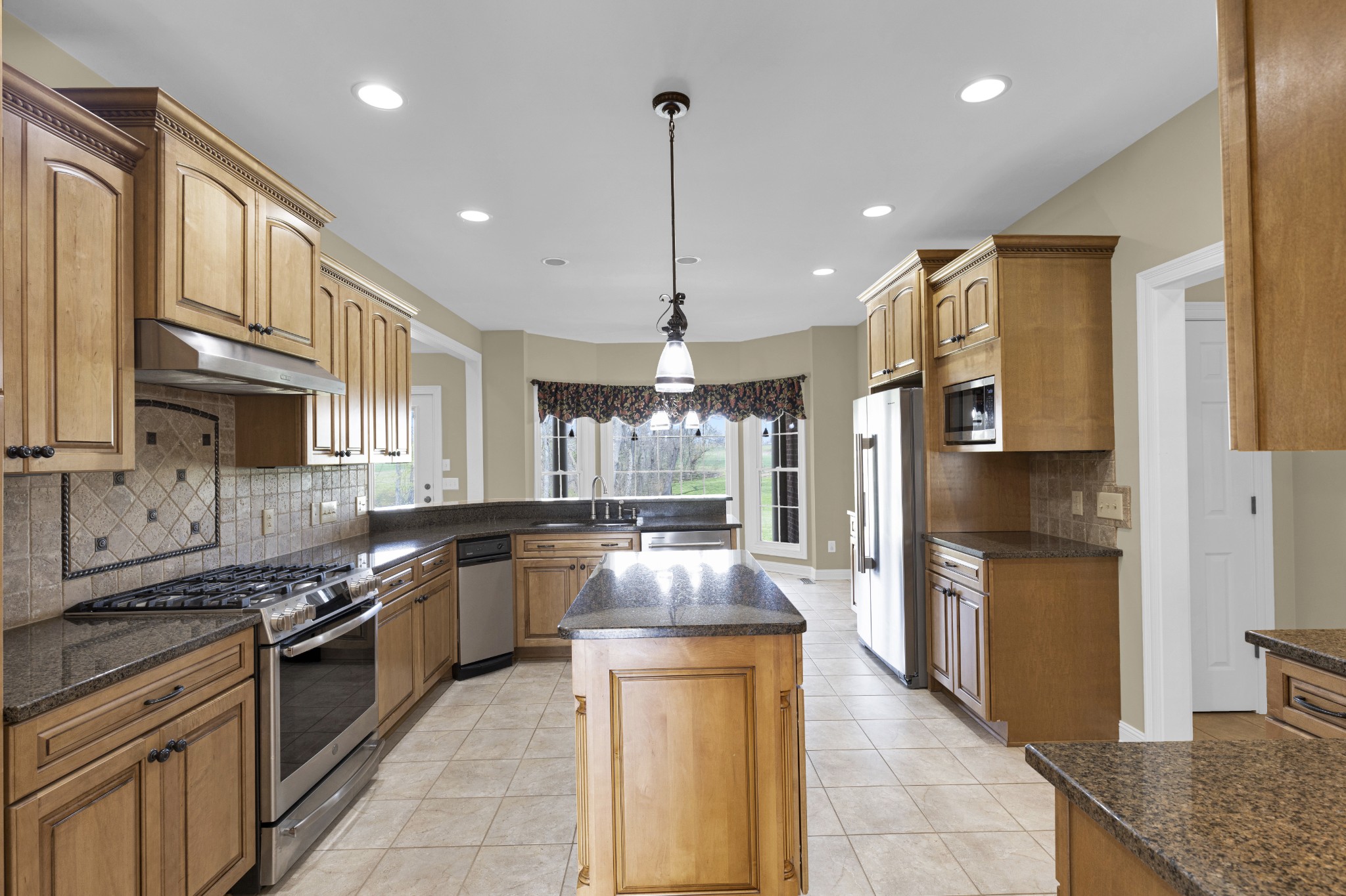 5144 Drake Road Cedar Hill, TN 37032 - Photo 43 of 80 a kitchen with stainless steel appliances granite countertop counter space a sink and cabinets