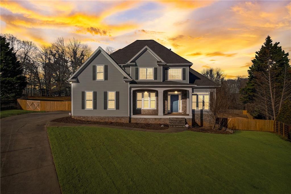 4930 Montclair Trail Cumming, GA 30040 - Photo 1 of 1 a front view of a house with a garden