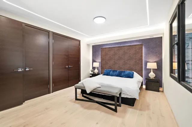 a bedroom with a bed and a mirror