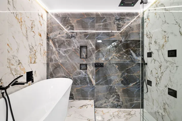 a bathroom with a shower and a sink