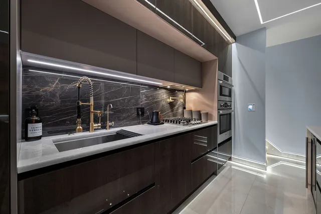 a kitchen with a sink and wooden cabinets