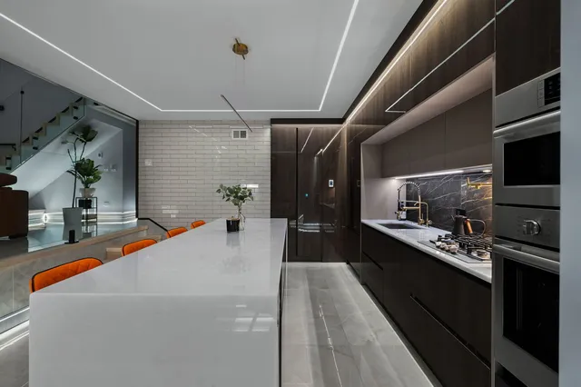 a living room with stainless steel appliances kitchen island granite countertop furniture a counter top space and a window