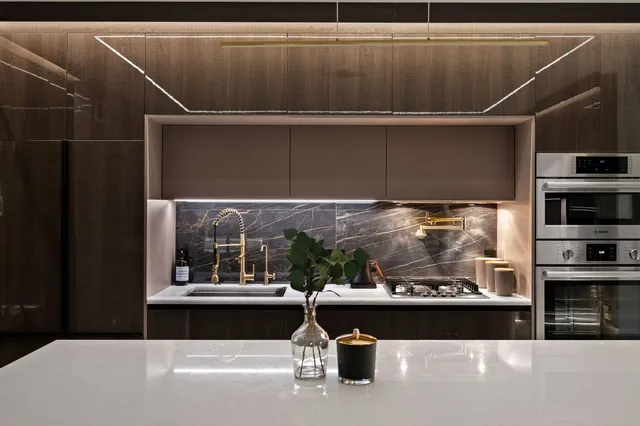 a view of a balcony with chairs and a potted plant