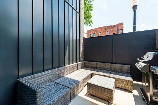 a wooden bench sitting in front of a building
