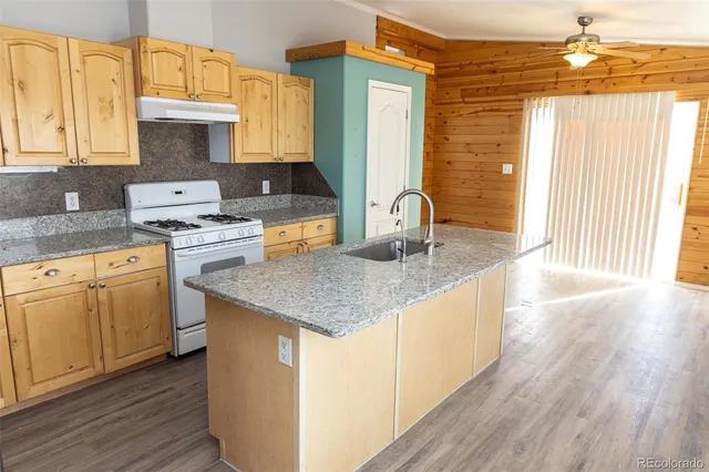 a kitchen with sink a stove and cabinets