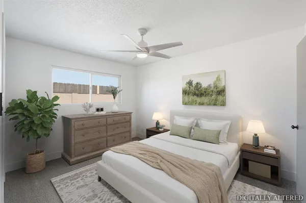 a bedroom with a bed and a potted plant