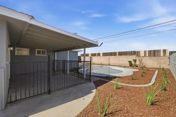 a view of a backyard with seating area
