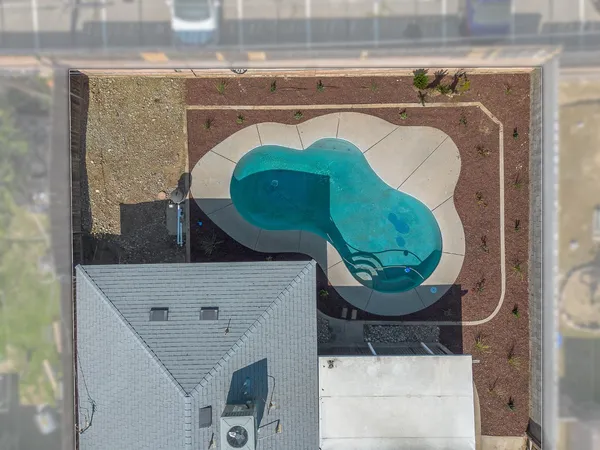 an aerial view of a house with a swimming pool and outdoor seating