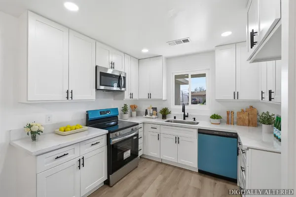 a kitchen with a sink stove and microwave