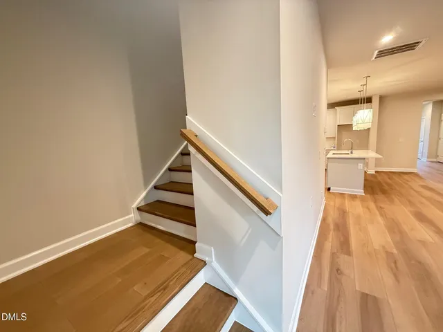 a view of a room with wooden floor and staircase