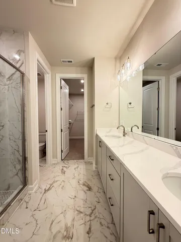 a spacious bathroom with a sink and a mirror