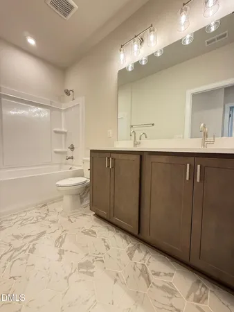 a bathroom with a sink toilet and a mirror