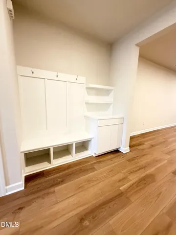 a view of a room with wooden floor