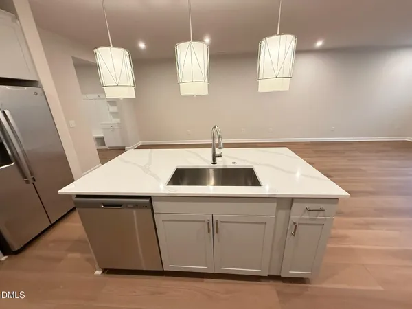 a kitchen that has a sink a stove and a microwave