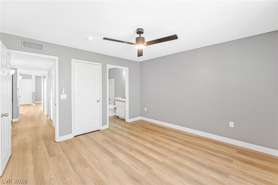 3318 North Decatur Boulevard, Unit 2152 Las Vegas, NV 89130 - Photo 15 of 58 Natural light wood-tone flooring and a modern ceiling fan complement this spacious sleeping area.