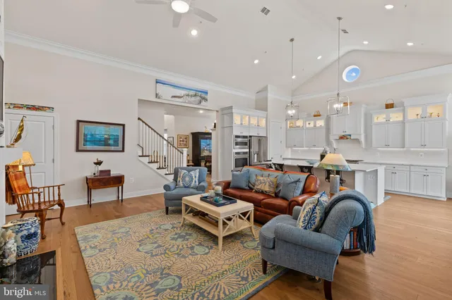 a living room with furniture kitchen view and a table