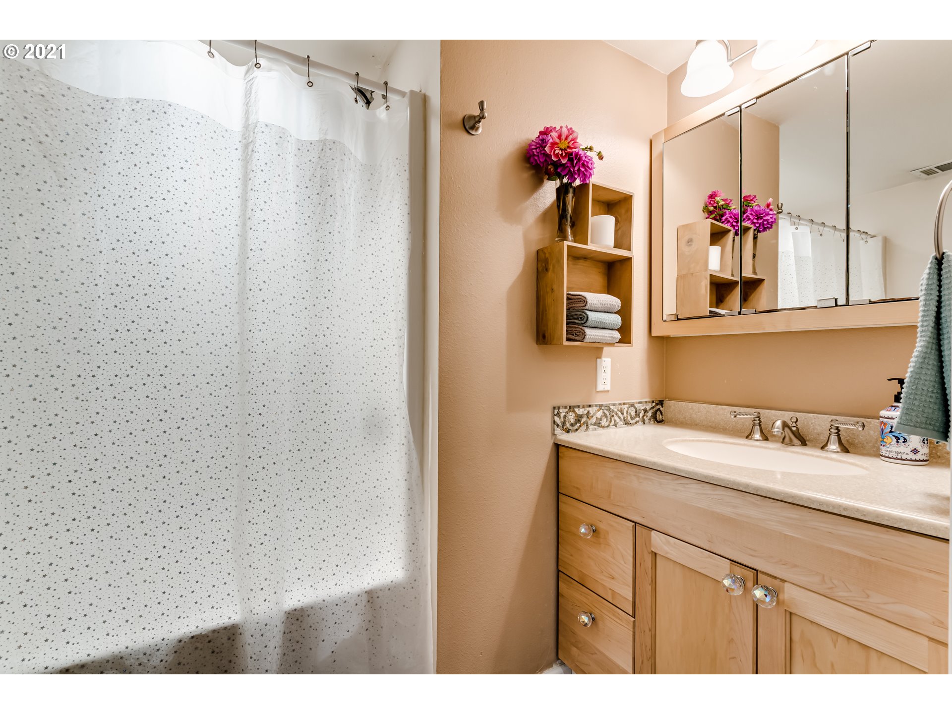 3250 B Street Springfield, OR 97478 - Photo 15 of 31 a bathroom with a sink vanity mirror and cabinets