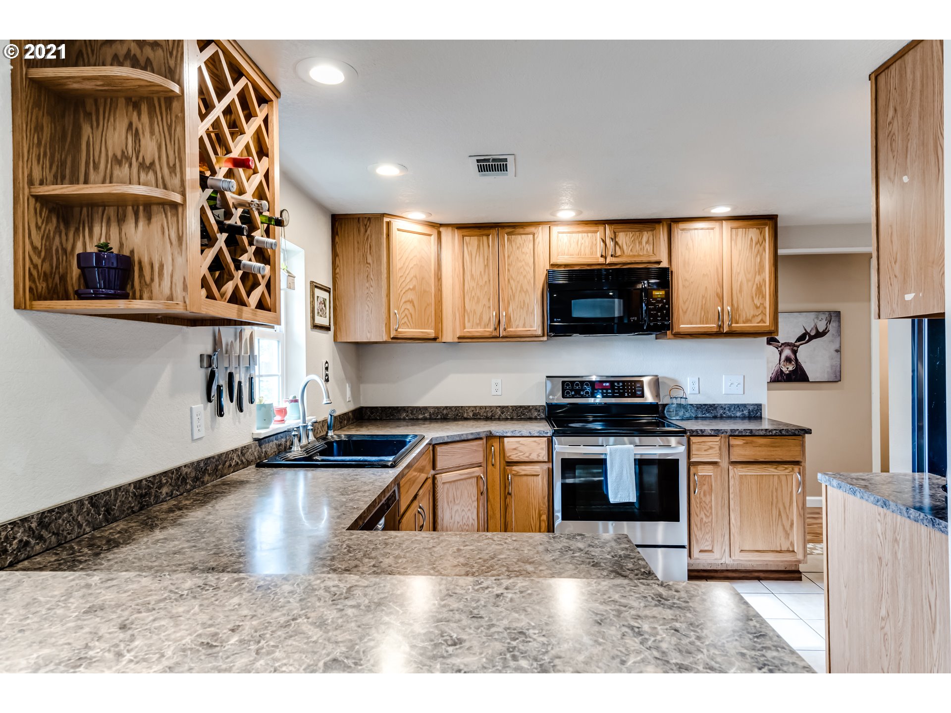 3250 B Street Springfield, OR 97478 - Photo 7 of 31 a kitchen with stainless steel appliances granite countertop a sink a stove and a microwave