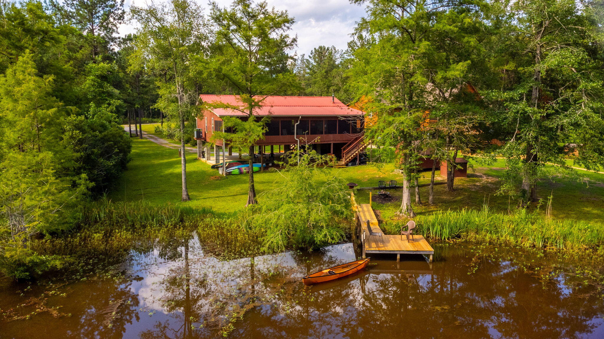 27583 Harbor Road Andalusia, AL 36421 - Photo 1 of 31 a view of a lake with a house in the background