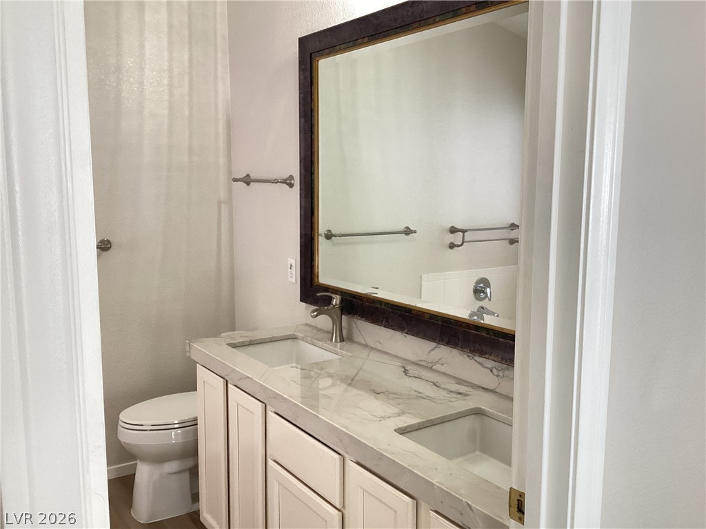 2135 Hidden Ranch Terrace Henderson, NV 89052 - Photo 20 of 27 Double vanity with stone counters provides ample space and elegant appeal.