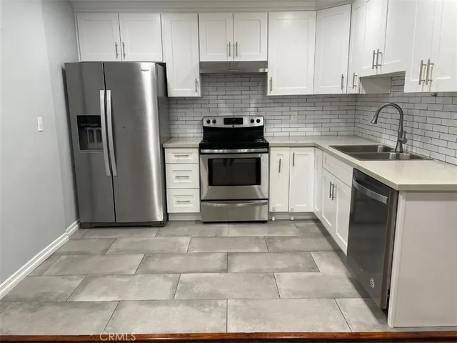 a kitchen with a sink stove and refrigerator