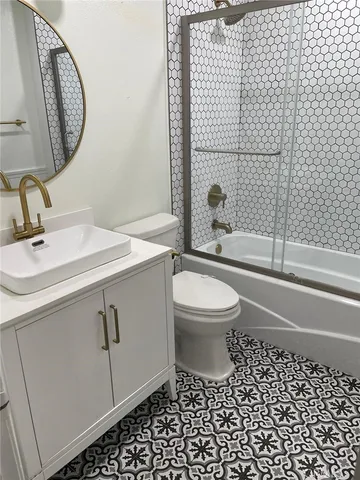 a bathroom with a toilet a sink and a mirror