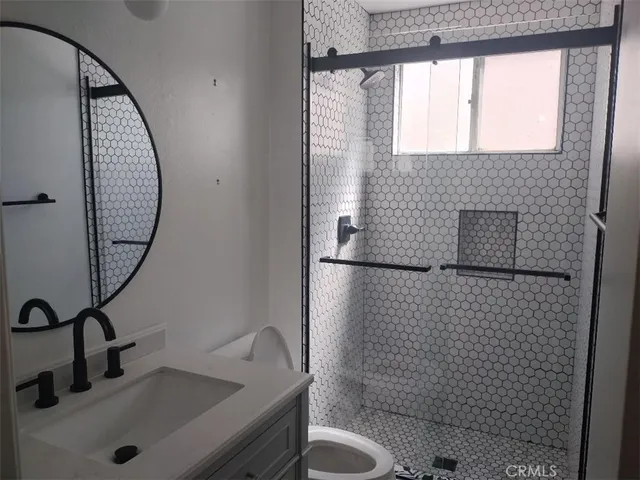 a bathroom with a sink toilet and shower
